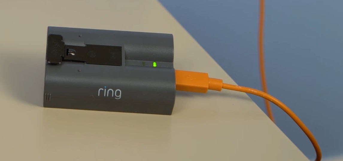 Plug the Ring doorbell battery to a power source using the orange USB cable